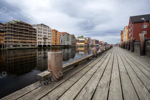 Preview: Wooden Boardwalk Leading Along Waterfront with Colorful Houses