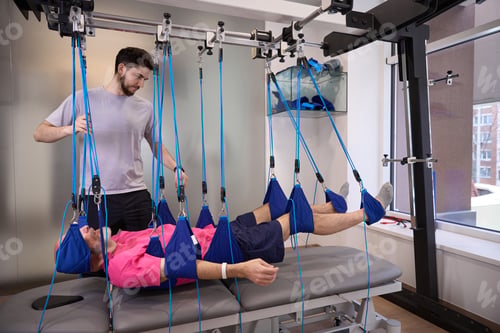 Preview: Adult male receiving physical therapy in rehabilitation clinic