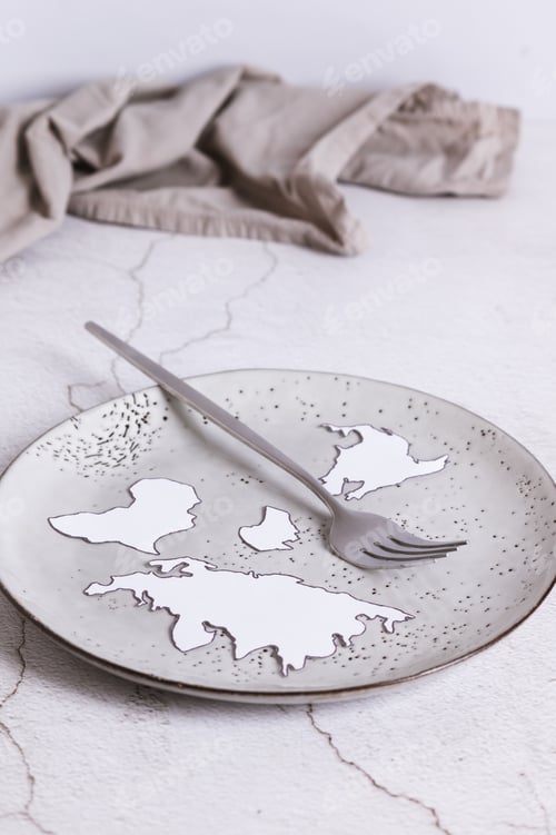 Preview: An empty plate without food, a fork and paper continents on the table vertical view