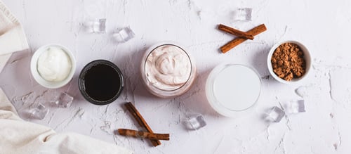 Preview: Delicious trendy protein coffee with yogurt in a glass on the table top view web banner