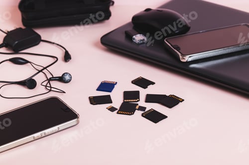 Preview: Flash drives, smartphones, a laptop, headphones, and a hard drive on the table