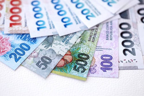 Preview: Argentine pesos money bills in big amount lies on white table close up