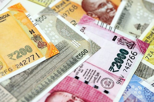 Preview: Big pile of Indian Rupees money bills banknotes close up. Lots of money of Indian INR currency cash