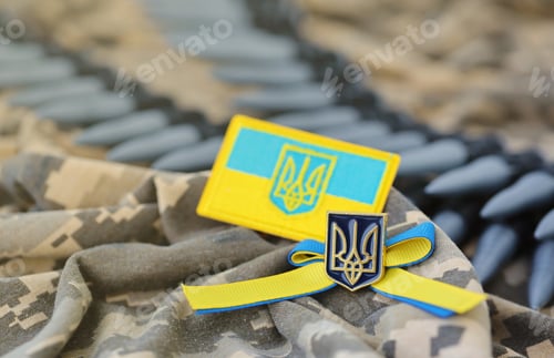 Preview: Ukrainian symbol and a machine gun belt on the camouflage uniform of a Ukrainian soldier. The Concep