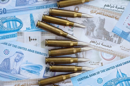 Preview: United Arab Emirates dirham currency money bills and rifle bullets. The concept of warfare and gun s