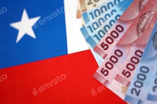 Preview: Chile Republic pesos money bills banknotes on flag close up. Chilean money