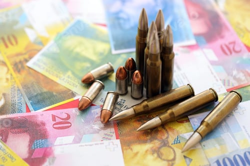 Preview: Swiss franc banknotes and bullets. The current francs money bills and ammo lies on table