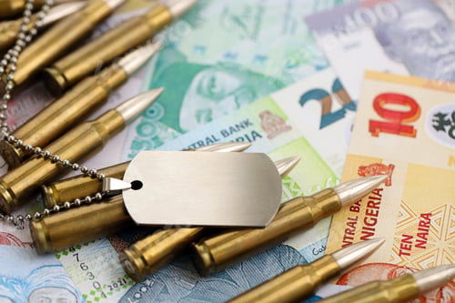 Preview: Nigerian naira currency money bills and rifle bullets with dogtag. The concept of warfare and army s