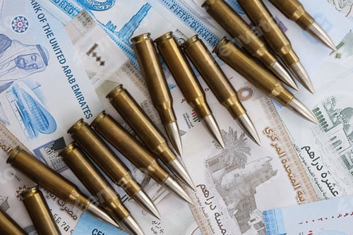 Preview: United Arab Emirates dirham currency money bills and rifle bullets. The concept of warfare and gun s