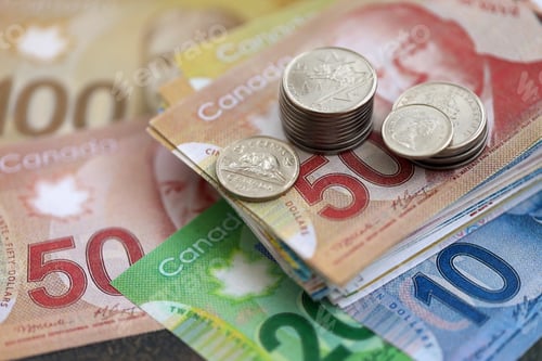 Preview: Canadian dollar money bills and cent coins pile on table. Canada coins on banknotes of CAD currency