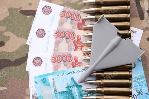 Preview: Russian money with bullets and kamikaze drone on multicam camouflage fabric close up