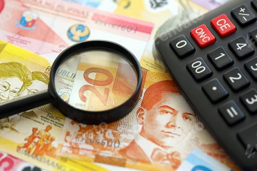 Preview: Philippines peso currency money bills and calculator with magnifying glass. The concept of taxation