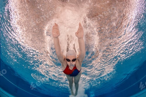 Preview: Swimmer propelling underwater during training in pool