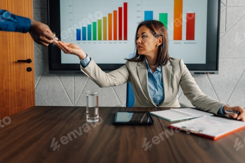 Preview: Businesswoman receiving medicine pill from colleague at work
