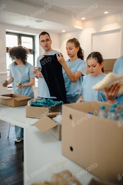 Preview: Volunteers sorting clothes and food donations for charity