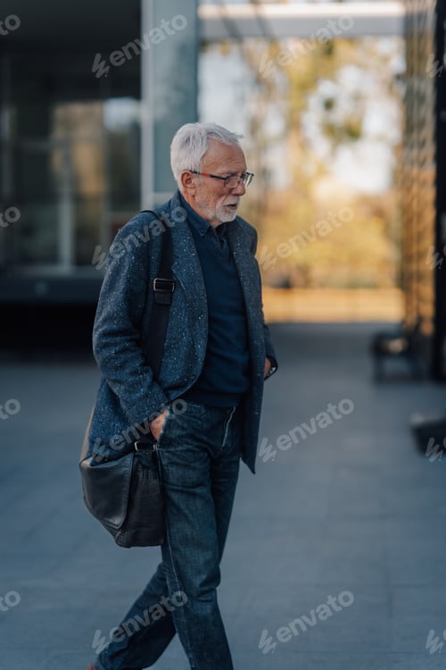 Preview: Senior man walking purposefully outdoors thinking