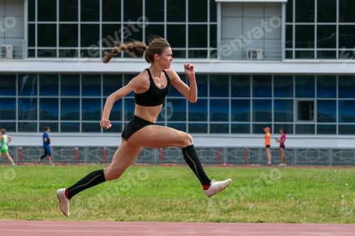 Preview: Female athlete in compression socks triple jump