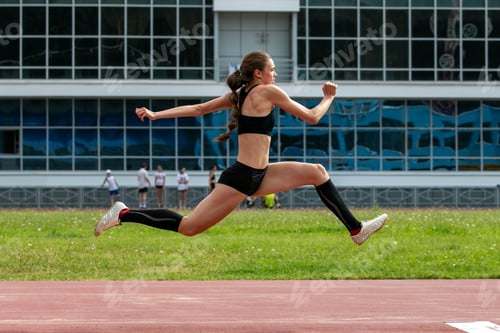 Preview: Beautiful female athlete triple jump
