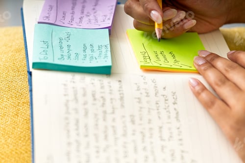 Preview: Person writing a to do list planning daily tasks
