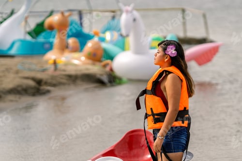 Preview: Young woman wearing life vest at summer lagoon