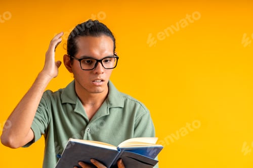 Preview: Young man experiencing confusion while reading book