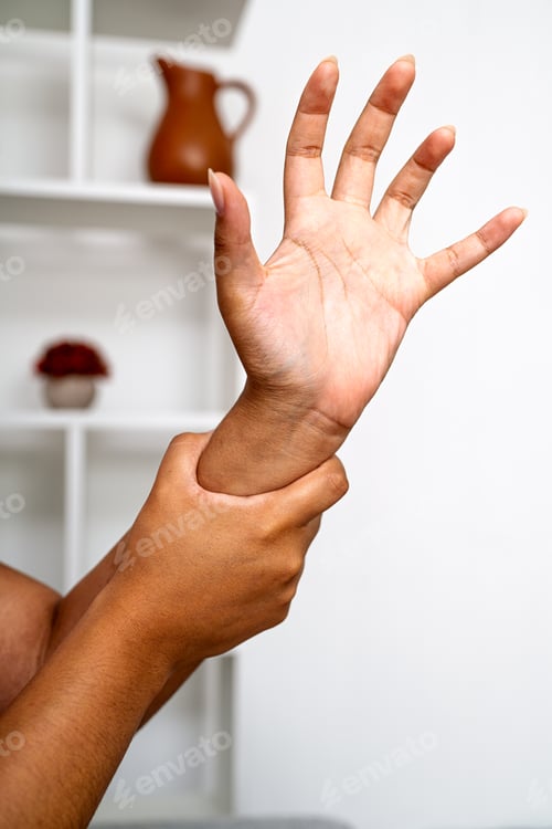 Preview: Person holding wrist feeling pain and discomfort