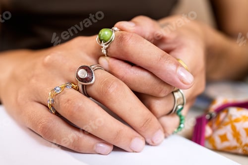 Preview: Woman's hands wearing creative handmade rings