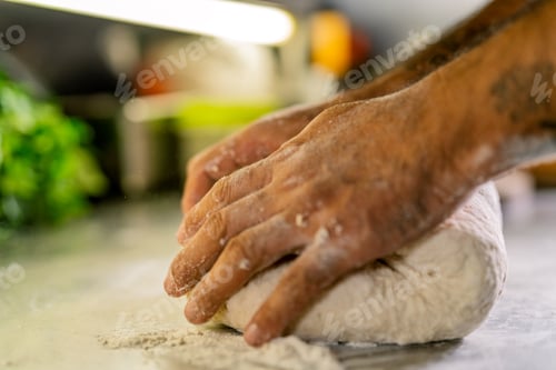 Preview: Chef hands kneading pizza dough on kitchen counter