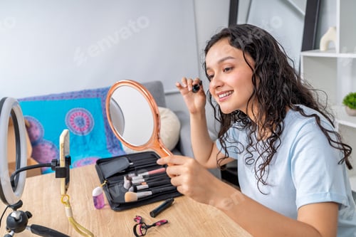 Preview: Young woman creating online beauty content at home