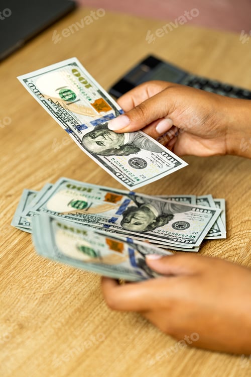 Preview: Hands counting new one hundred dollar bills
