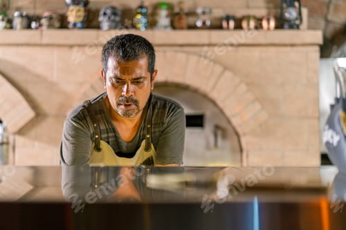 Preview: Chef focusing on artisanal pizza preparation at brick oven