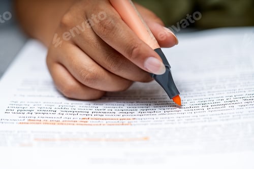Preview: Student hand highlighting important text in a book