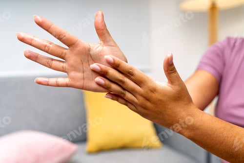 Preview: Woman massaging hand applying cream for skin care