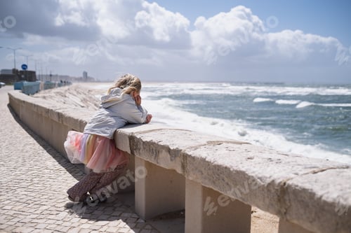 Preview: Little Girl Contemplating the Sea on a Sunny Windy Day