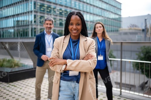 Preview: African businesswoman smiling in diverse professional team leadership