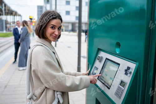 Preview: Woman buying public transport ticket from vending machine