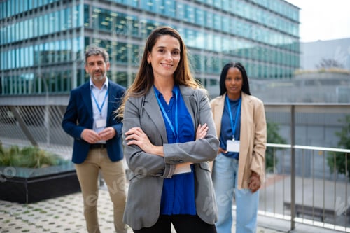Preview: Business woman standing with diverse corporate team