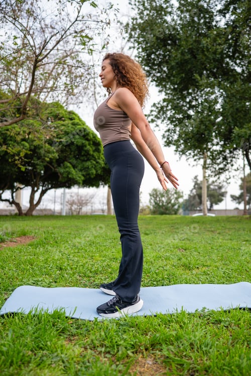 Preview: Woman stretching in an outdoor park for wellness