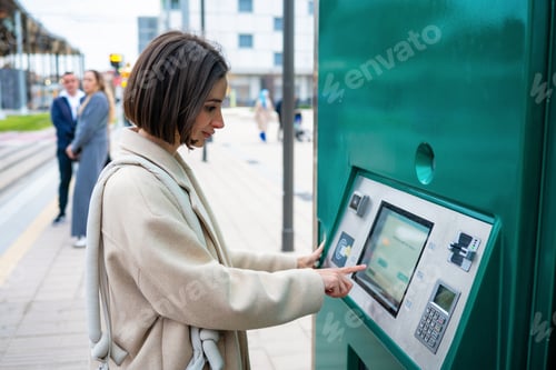 Preview: Woman buying public transport ticket at terminal kiosk