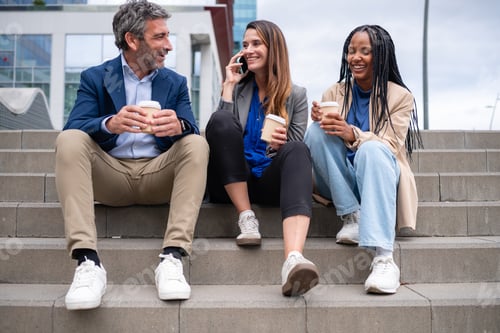 Preview: Multiracial business people having coffee break on office stairs