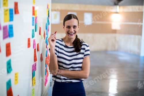 Preview: Whiteboard is showing colorful sticky notes and red marker is resting on ledge in modern workshop