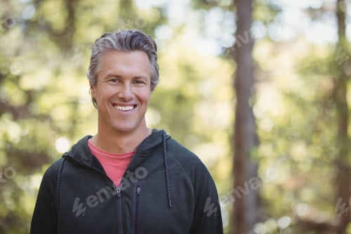 Preview: Dark zip-up hoodie and coral T-shirt are resting against sunlit wooded background with bokeh