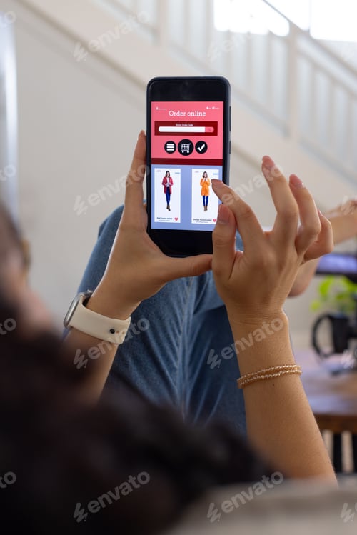 Preview: Adult female reclining on couch, scrolling on phone after seeing Order online, wearing smartwatch