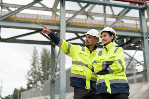 Preview: Male and female petrochemical engineers survey refinery pipelines
