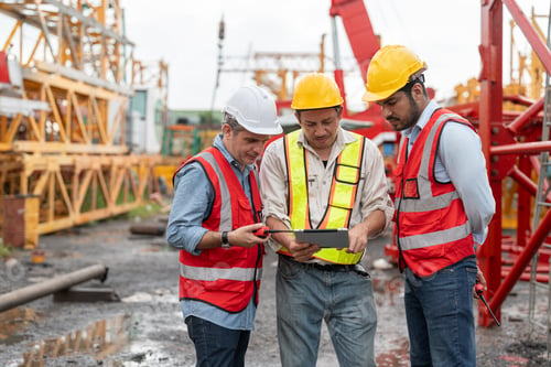Preview: Construction engineers review project plans on tablet at work site