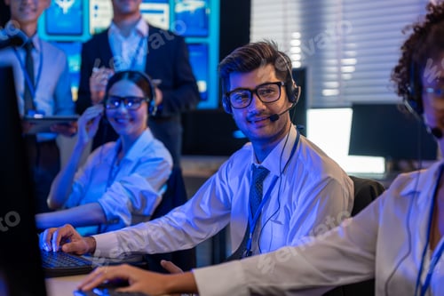Preview: Male customer service agent works in night control room