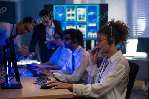 Preview: Customer service team monitors computers in night control room