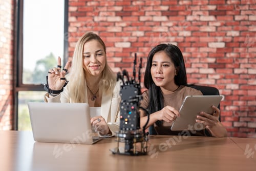 Preview: Female engineering student programs robotic finger arm in laboratory