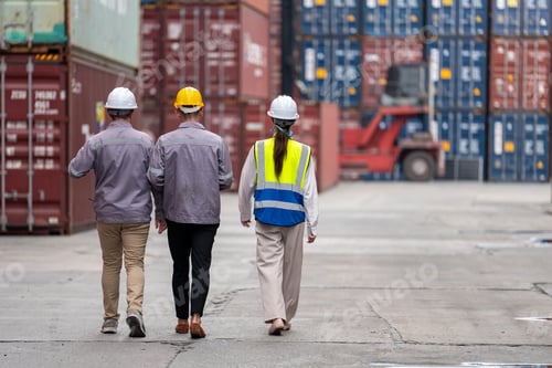 Preview: Logistics team inspects stacked containers at shipping yard