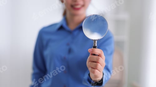 Preview: Asian business woman holding magnifying glass search analysis investigation inspection research conc